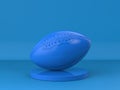 Blue rugby ball on blue background