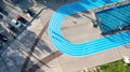 Blue running track on public sports ground aerial view Royalty Free Stock Photo