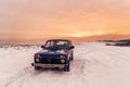 Blue Russian off-road car Lada Niva 4x4 VAZ 2121/21214 parked on the snow field.