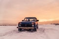 Blue Russian off-road car Lada Niva 4x4 VAZ 2121/21214 parked on the snow field.