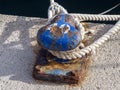 Blue rusty bitt in the harbor of Ibiza on a sunny day Royalty Free Stock Photo