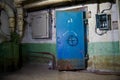 Blue rusty hermetical door of old abandoned Soviet bomb shelter Royalty Free Stock Photo