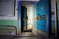 Blue rusty hermetical door of old abandoned Soviet bomb shelter