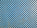 Blue rusty metal grate texture with holes close