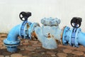 Blue rusty metal industrial water pipes with a valve. Royalty Free Stock Photo