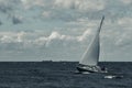 Blue sailboat at storm