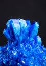 Blue salt crystal isolated on black background