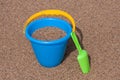 Blue Sand Bucket & Green shovel on the beach Royalty Free Stock Photo