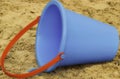 Blue Sand Bucket with red handle, Children`s Beach toy Royalty Free Stock Photo