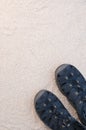 Blue sandals on white sand