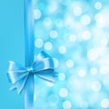 Blue satin bow knot on blue background with bokeh light effects, vector illustration Royalty Free Stock Photo