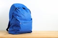 Blue school backpack, sports bag on the table.