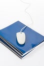 Blue school textbook and computer mouse Royalty Free Stock Photo