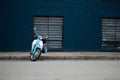 Blue scooter bike against a blue wall Royalty Free Stock Photo