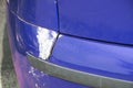 Blue scratched car with damaged paint in crash accident or parking lot and dented damage of metal body from collision Royalty Free Stock Photo