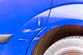 Blue scratched car with damaged paint in crash accident on the street or collision on parking lot in the city Royalty Free Stock Photo