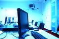 Blue screens in computer room Royalty Free Stock Photo