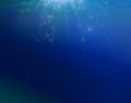 Blue sea background with stars gliterin falling from above. Royalty Free Stock Photo