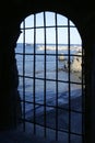 Blue sea behind the jail, arch window Royalty Free Stock Photo