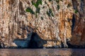 Blue sea and the characteristic caves of Cala Luna, a beach in the Golfo di Orosei, Sardinia, Italy. Big sea caves in the Royalty Free Stock Photo