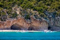 Blue sea and the characteristic caves of Cala Luna, a beach in the Golfo di Orosei, Sardinia, Italy. Big sea caves in the Royalty Free Stock Photo