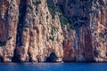 Blue sea and the characteristic caves of Cala Luna, a beach in the Golfo di Orosei, Sardinia, Italy. Big sea caves in the Royalty Free Stock Photo