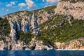 Blue sea and the characteristic caves of Cala Luna, a beach in the Golfo di Orosei, Sardinia, Italy. Big sea caves in the Royalty Free Stock Photo