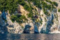 Blue sea and the characteristic caves of Cala Luna, a beach in the Golfo di Orosei, Sardinia, Italy. Big sea caves in the Royalty Free Stock Photo