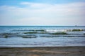 The blue sea in the clear sky. It is the beautiful view of beach and the sea which has small wave Royalty Free Stock Photo