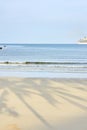 Blue sea. Clear sky. Shadows on sand Royalty Free Stock Photo