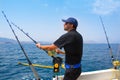 Blue sea fisherman in trolling boat with downrigger Royalty Free Stock Photo