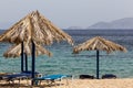Blue sea, golden sand, sunbeds and umbrellas on the beach. Ios i Royalty Free Stock Photo