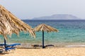 Blue sea, golden sand, sunbeds and umbrellas on the beach. Ios i Royalty Free Stock Photo