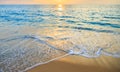 Blue sea and golden sand with sunset background Royalty Free Stock Photo