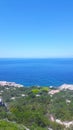 The blue sea and the horizon between the bushes in greece.