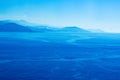 Blue sea and mountains on the horizon. Monochrome landscape. Royalty Free Stock Photo