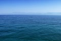 Blue sea or ocean water surface with horizon and sky Royalty Free Stock Photo