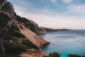 Blue sea and a rocky shore on a cloudy day Royalty Free Stock Photo