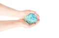 Blue sea salt for a bath in the hands of a girl isolated on white background Royalty Free Stock Photo