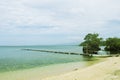 Blue sea sand beach with wooden pier landscape. Romantic seaside view toned photo. Royalty Free Stock Photo