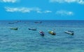 blue sea with several traditional Indonesian boats