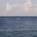 Blue Sea sky cumulus cloud landscape view background. Calm water alone fishing boat. Destination aim progress concept Royalty Free Stock Photo