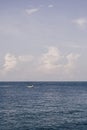 Blue Sea sky cumulus cloud landscape view background. Calm water alone fishing boat. Destination aim progress concept Royalty Free Stock Photo