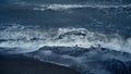 Blue sea tide storming iceland beach. Ocean wave foam crashing sand shore nature Royalty Free Stock Photo