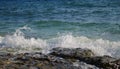 Blue sea view with white wave splashing over beach rock. Volcanic seaside during high tide Royalty Free Stock Photo