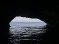 Blue sea water cave entrance inside front view to horizon line