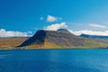 Blue sea water on mountain landscape in isafjordur, iceland. Hilly coastline on sunny blue sky. Summer vacation on Royalty Free Stock Photo