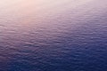 Blue sea water with soft reflection of sunset sun on calm surface. Beautiful blue colored simple background Royalty Free Stock Photo