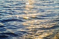 Blue sea water surface at sunset with sparks Royalty Free Stock Photo