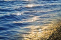 Blue sea water surface at sunset with sparks Royalty Free Stock Photo